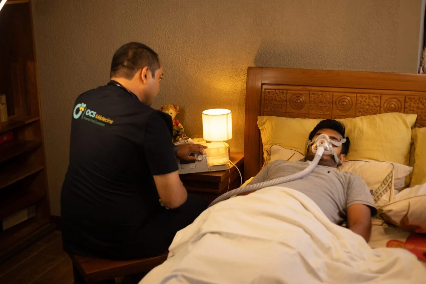 An OCS Médecins doctor attending to a hotel guest in their room