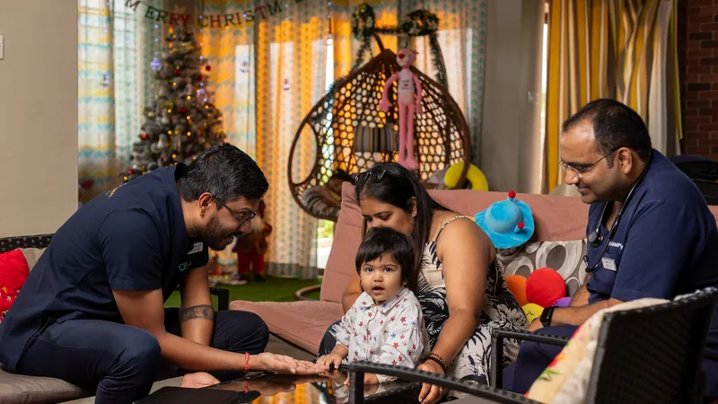 OCS clinicians speaking with a family and young child at home.